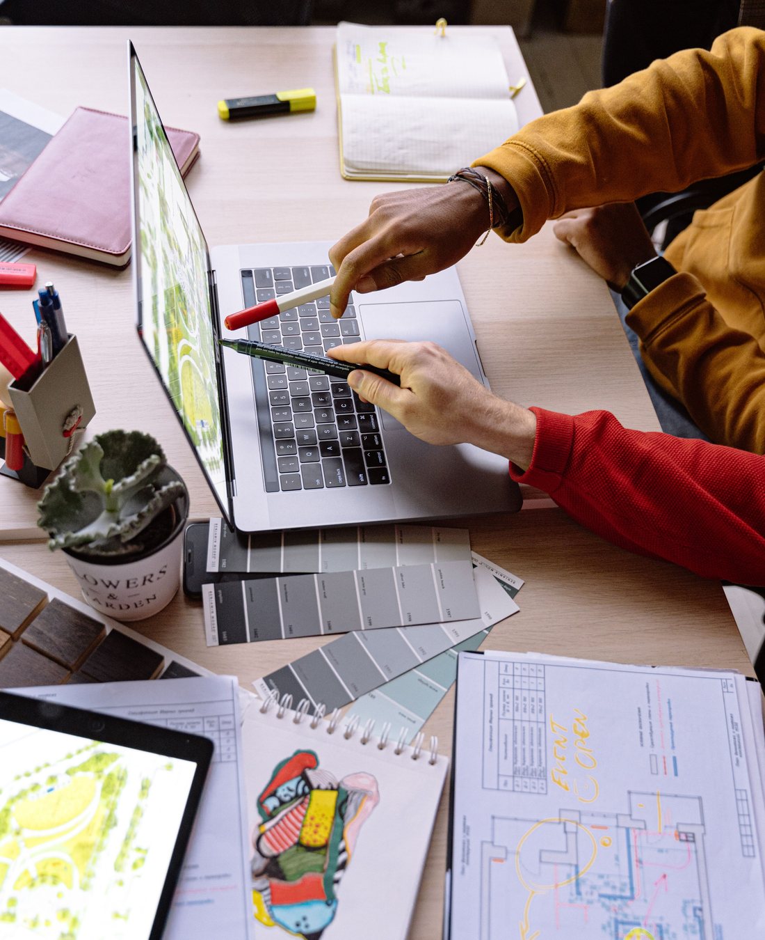 Designers reviewing a digital project on a laptop